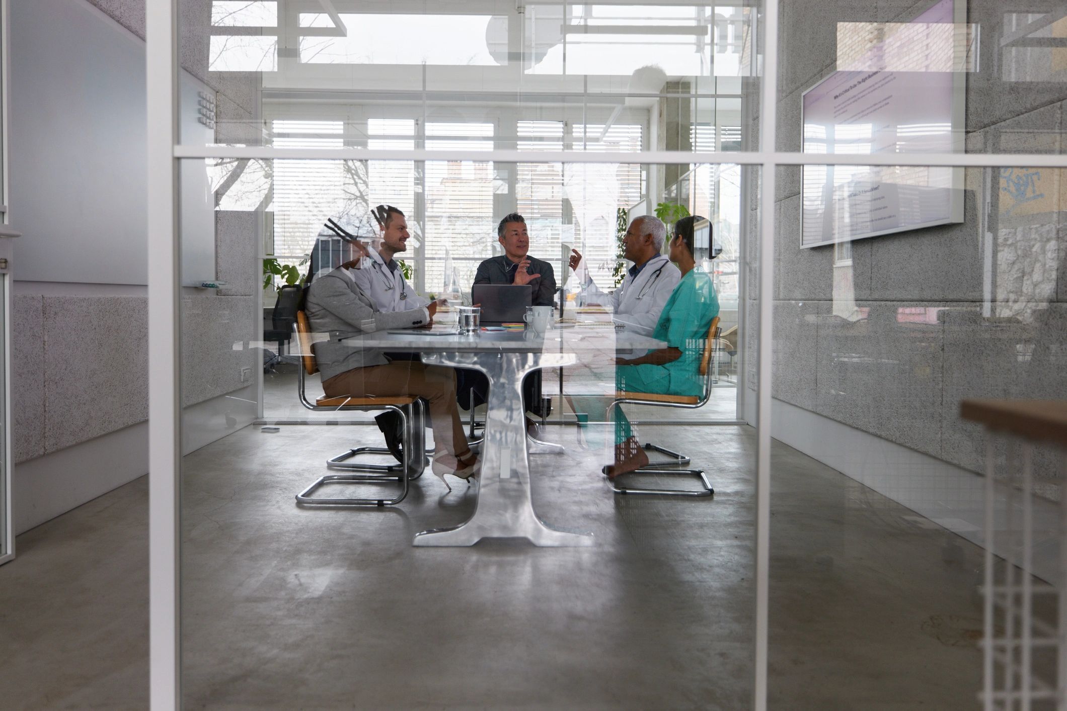 Healthcare administrators and medical experts meeting in an office