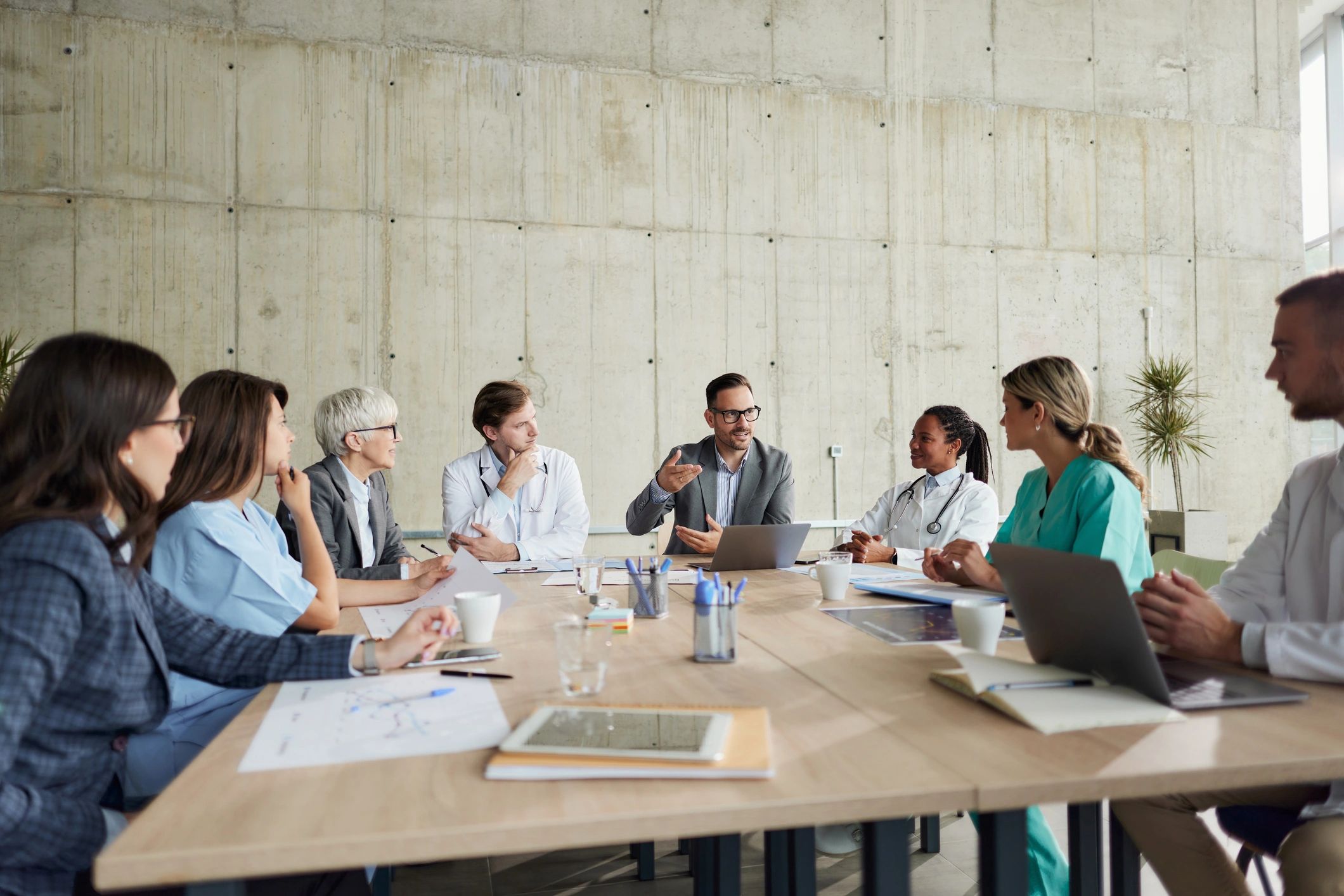 Healthcare administrators and doctors in a collaborative meeting