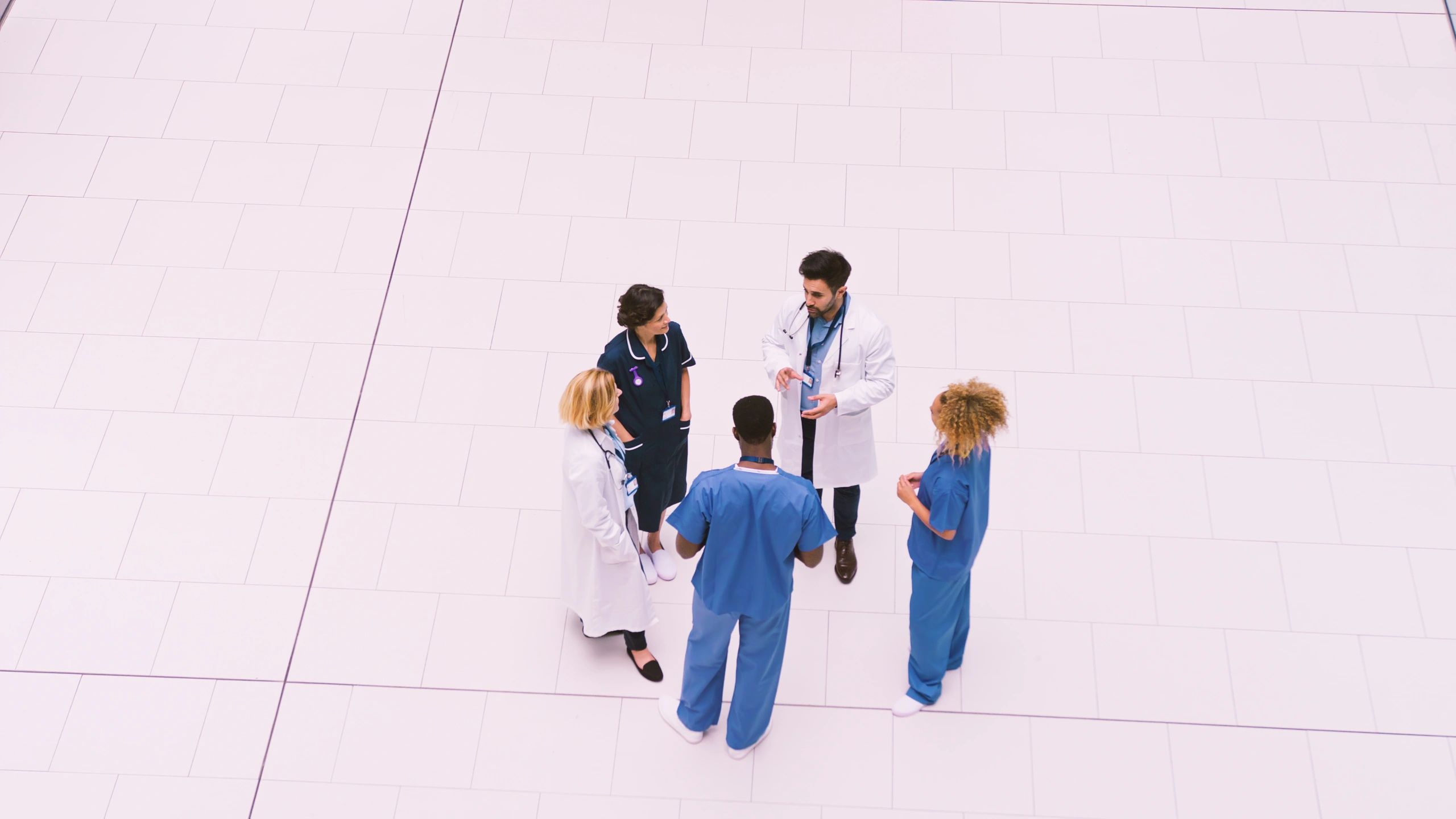 Medical staff meeting in a modern hospital lobby