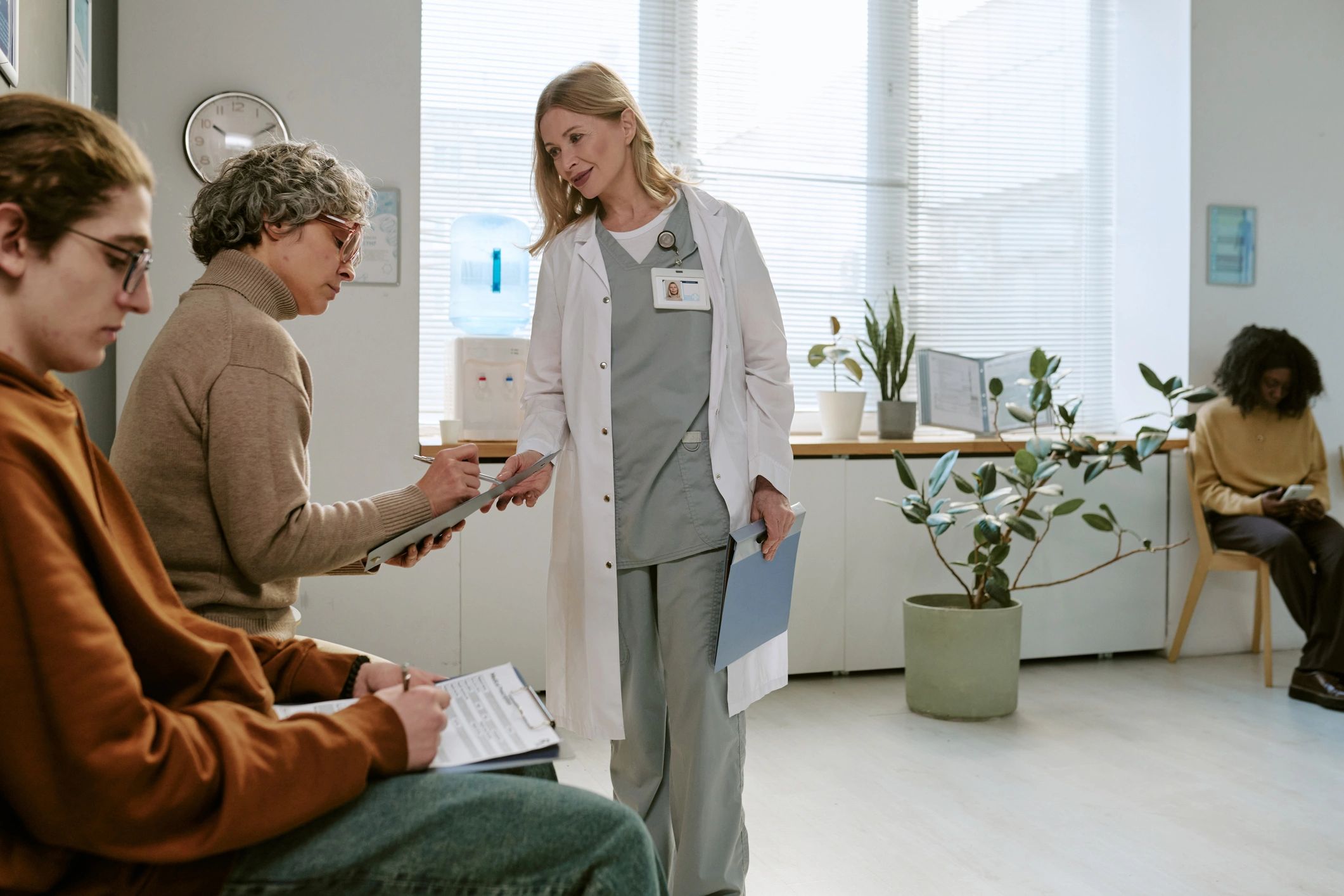 Doctor assisting a patient with clinic intake forms