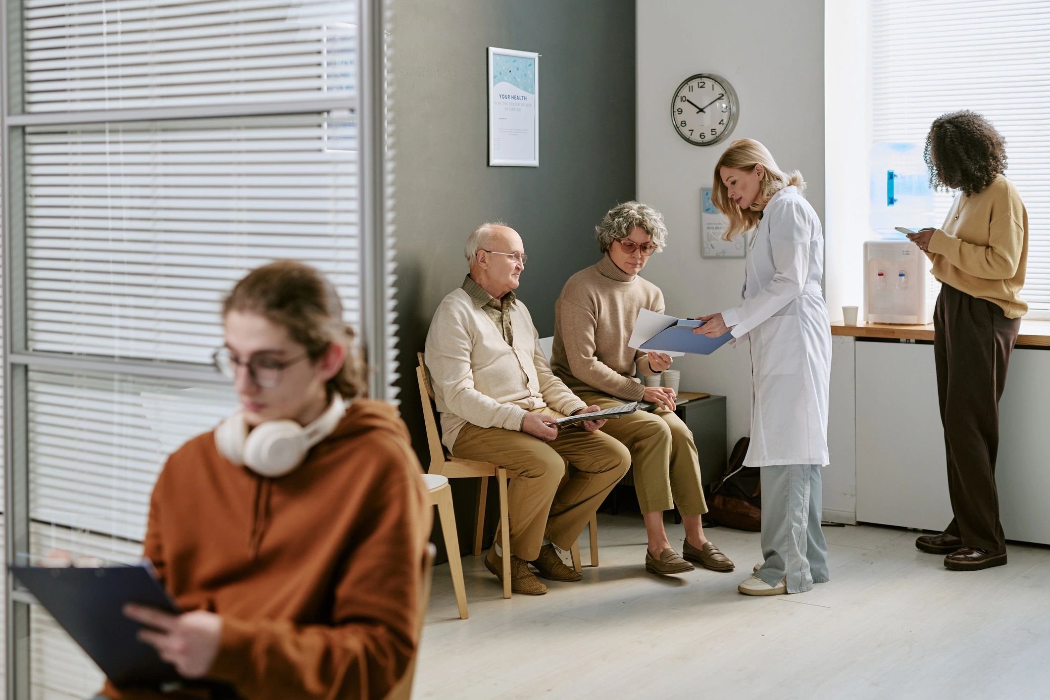 Doctor consulting patients in a clinic waiting room