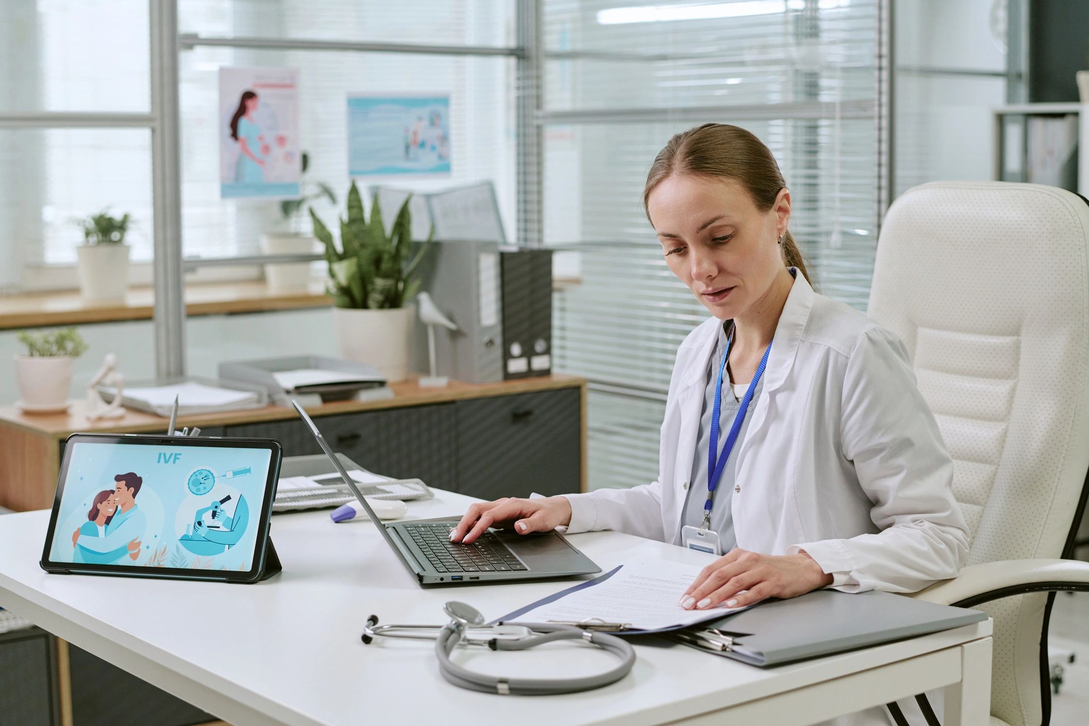 Doctor reviewing data on laptop in clinic