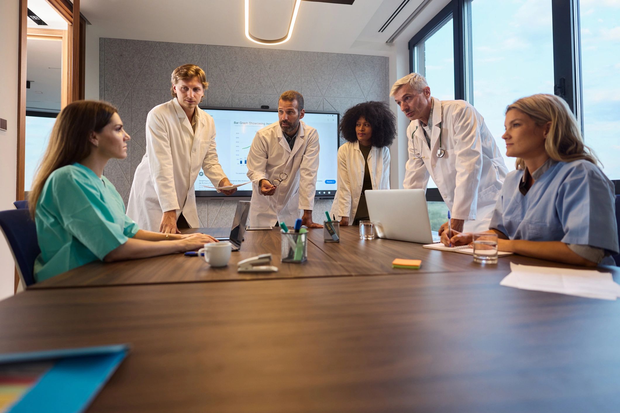 Medical leadership team meeting in a modern office